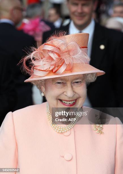 Britain's Queen Elizabeth II is pictured as she hosts the first Buckingham Palace garden party of the summer in London, on May 22, 2012. About 8,000...