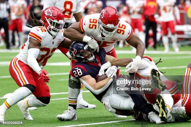 Chris Jones of the Kansas City Chiefs tackles Rex Burkhead of the Houston Texans during the first quarter of the game at NRG Stadium on December 18,...