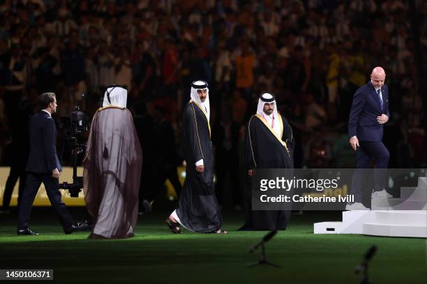 Gianni Infantino, President of FIFA, French President Emmanuel Macron, Sheikh Tamim bin Hamad Al Thani, Emir of Qatar, are seen during the award...