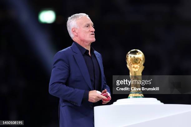 Didier Deschamps, Head Coach of France, looks dejected as he walks past the FIFA World Cup Qatar 2022 Winner's Trophy during the award ceremony...