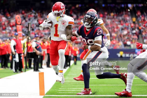 Jerick McKinnon of the Kansas City Chiefs rushes for a touchdown as M.J. Stewart of the Houston Texans defends during the second quarter at NRG...