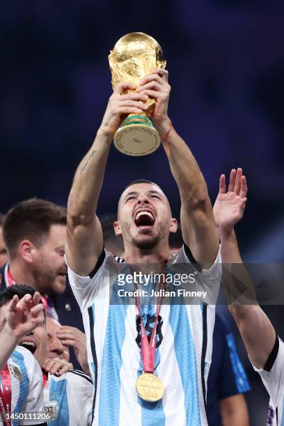 Guido Rodriguez of Argentina lifts the FIFA World Cup Qatar 2022 Winner's Trophy during the FIFA World Cup Qatar 2022 Final match between Argentina...