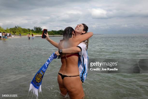 Argentina soccer fans, Lucia Vaira and Bianca Vanrell react as their team beats France in the World Cup Final as fans watch the game during the Haig...