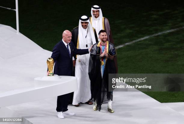 Lionel Messi of Argentina is presented with a traditional robe by Sheikh Tamim bin Hamad Al Thani, Emir of Qatar, during the awards ceremony after...