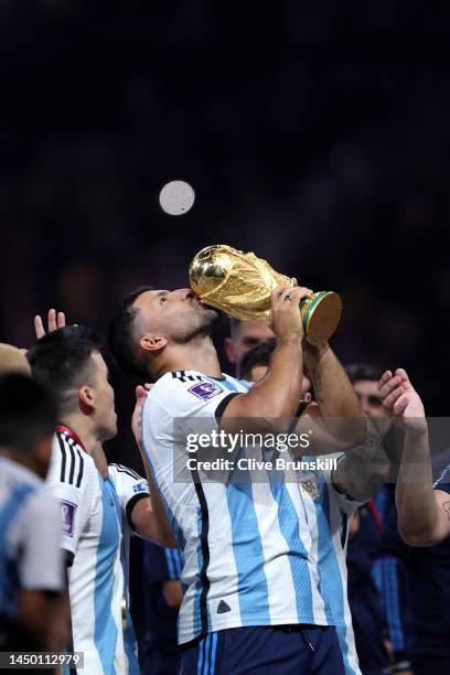 Former Argentina player Sergio Aguero lifts the FIFA World Cup Qatar 2022 Winner's Trophy during the FIFA World Cup Qatar 2022 Final match between...