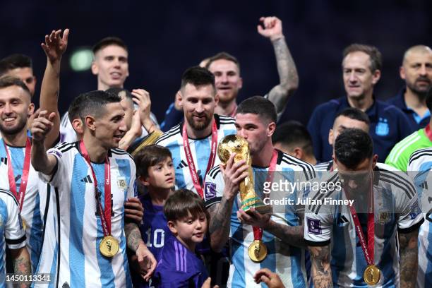 Rodrigo De Paul of Argentina kisses the FIFA World Cup Qatar 2022 Winner's Trophy during the FIFA World Cup Qatar 2022 Final match between Argentina...