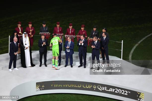 Emiliano Martinez of Argentina receives the Golden Glove award as Gianni Infantino President of FIFA, The Emir of Qatar Sheikh Tamim bin Hamad...