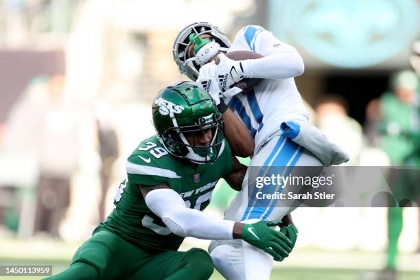 Kalif Raymond of the Detroit Lions is tackled by Will Parks of the New York Jets during the first quarter at MetLife Stadium on December 18, 2022 in...