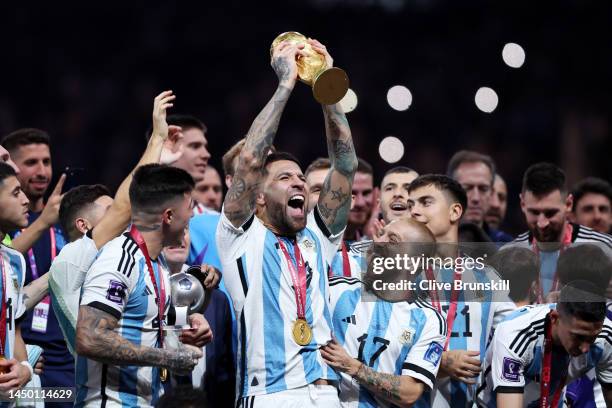 Nicolas Otamendi of Argentina lifts the FIFA World Cup Qatar 2022 Winner's Trophy during the FIFA World Cup Qatar 2022 Final match between Argentina...