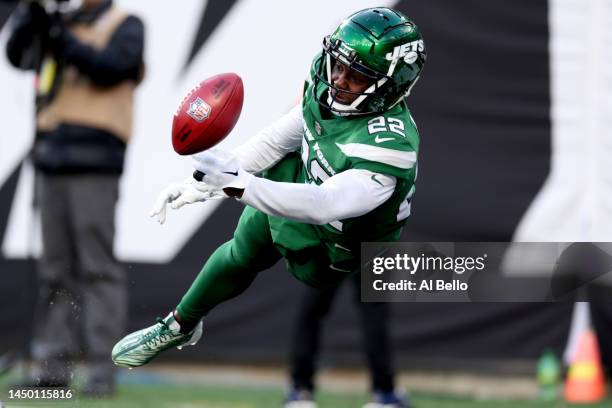 Tony Adams of the New York Jets attempts to down the ball on a punt during the first half against the Detroit Lions at MetLife Stadium on December...