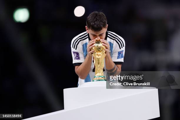 Paulo Dybala of Argentina kisses the FIFA World Cup winning trophy during the award ceremony following the FIFA World Cup Qatar 2022 Final match...