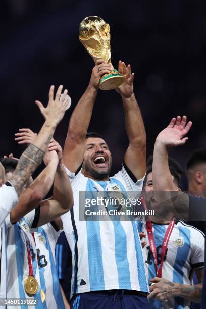 Sergio Aguero, former Argentina player lifts the FIFA World Cup Qatar 2022 Winner's Trophy during the FIFA World Cup Qatar 2022 Final match between...