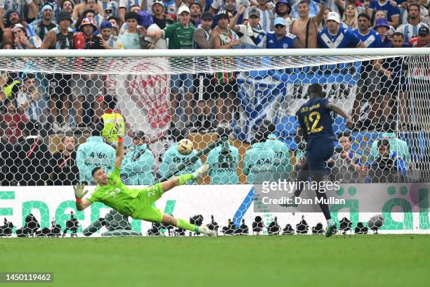 Randal Kolo Muani of France scores the team's fourth penalty past Emiliano Martinez of Argentina in the penalty shoot out during the FIFA World Cup...