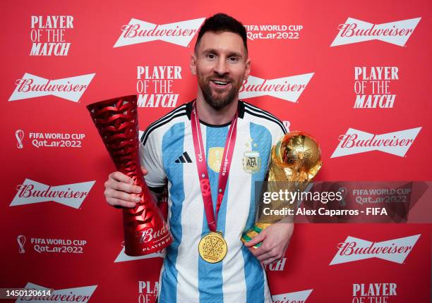 Lionel Messi of Argentina poses with the Budweiser Player of the Match Trophy and the FIFA World Cup Qatar 2022 trophy following the FIFA World Cup...