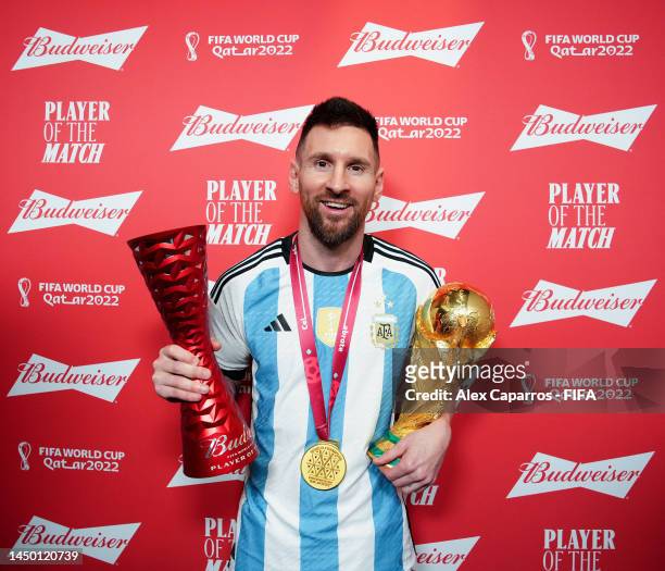 Lionel Messi of Argentina poses with the Budweiser Player of the Match Trophy and the FIFA World Cup Qatar 2022 trophy following the FIFA World Cup...