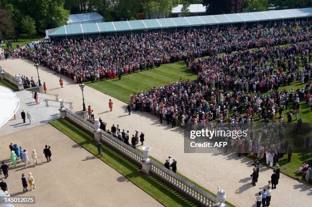 Guests wait to meet Britain's Queen Elizabeth II and Prince Philip as they host the first Buckingham Palace garden party of the summer in London, on...