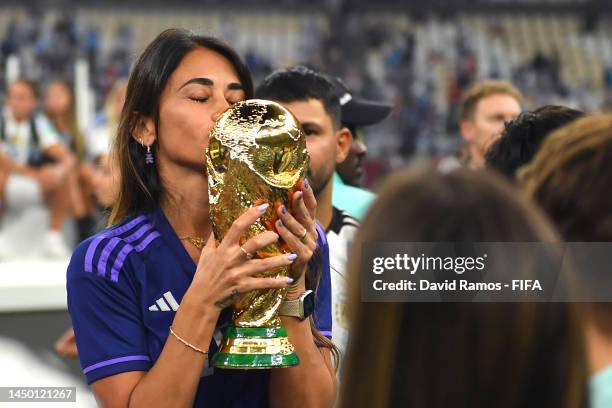 Antonela Roccuzzo, wife of Lionel Messi of Argentina celebrates with the FIFA World Cup Qatar 2022 Winner's Trophy after the team's victory during...