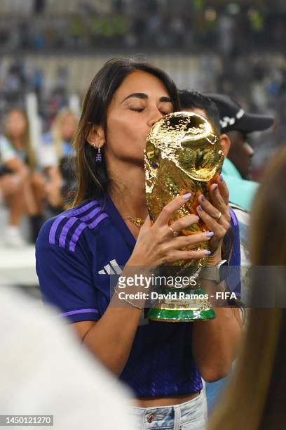 Antonela Roccuzzo, wife of Lionel Messi of Argentina celebrates with the FIFA World Cup Qatar 2022 Winner's Trophy after the team's victory during...