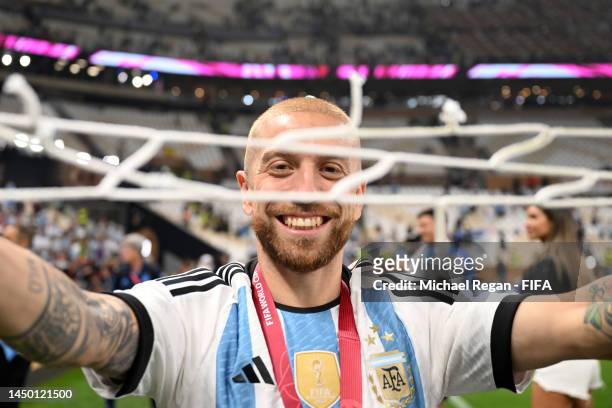 Alejandro Gomez of Argentina celebrates after the team's victory with a piece of the net during the FIFA World Cup Qatar 2022 Final match between...
