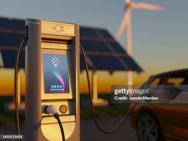 electric car charging with wind turbines - electric vehicle charging station stock pictures, royalty-free photos & images