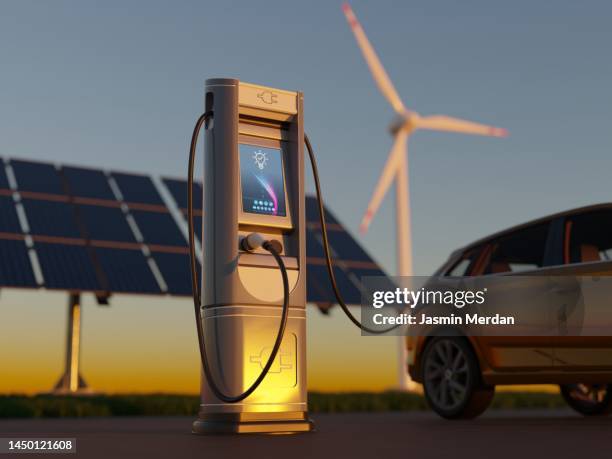 electric car charging with wind turbines and solar panel - electric cars stockfoto's en -beelden