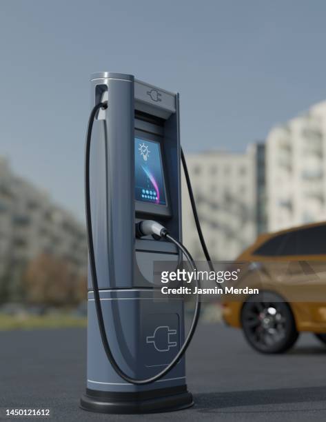 electric car charging on city street - stromtankstelle stock-fotos und bilder