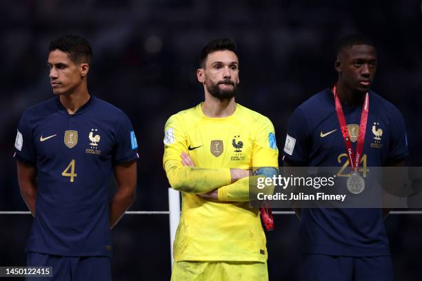 Raphael Varane, Hugo Lloris and Ibrahima Konate of France show dejection at the award ceremony following the FIFA World Cup Qatar 2022 Final match...