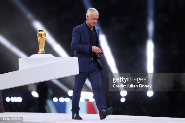 Didier Deschamps, Head Coach of France looks dejected as he walks past the FIFA World Cup Qatar 2022 Winner's Trophy after presented the medal at the...
