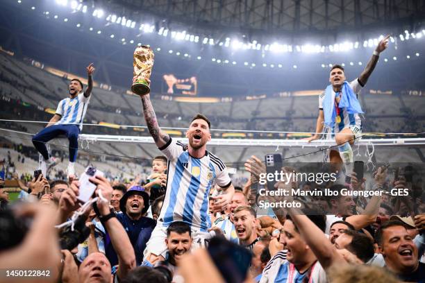 Lionel Messi of Argentinia celebrate with their FIFA World Cup Qatar 2022 trophy after the teams victory with fans during the FIFA World Cup Qatar...