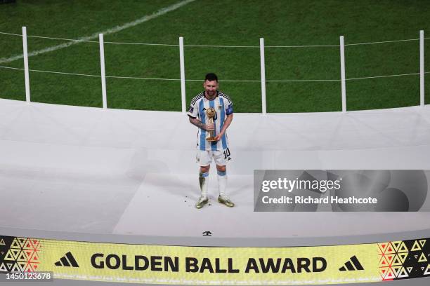 Lionel Messi of Argentina poses for a photo with the adidas Golden Ball award during the FIFA World Cup Qatar 2022 Final match between Argentina and...