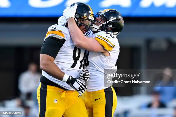 Cameron Heyward of the Pittsburgh Steelers celebrates with T.J. Watt after a sack against Sam Darnold of the Carolina Panthers during the third...