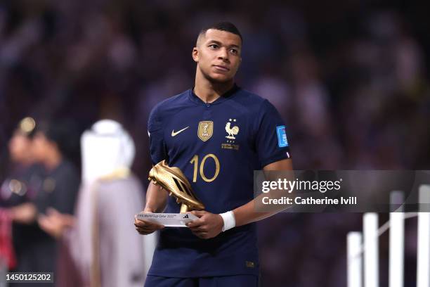 Kylian Mbappe of France poses with the adidas Golden Boot torphy at the award ceremony following the FIFA World Cup Qatar 2022 Final match between...