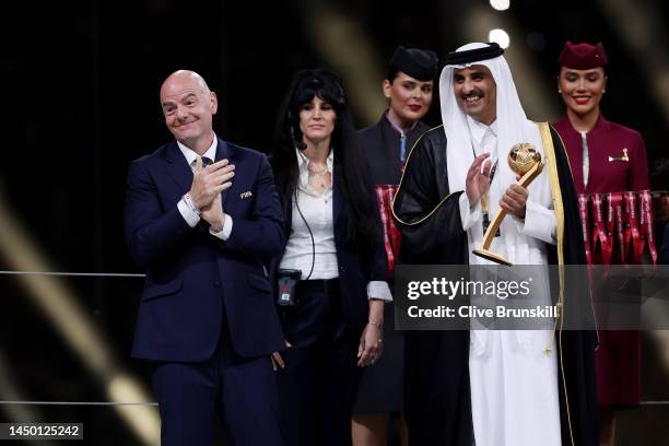 LGianni Infantino, President of FIFA, and Sheikh Tamim bin Hamad Al Thani, Emir of Qatar, applaud Lionel Messi of Argentina before presenting the...