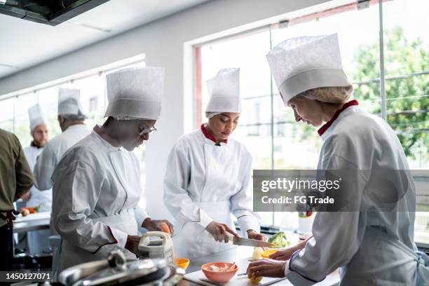 coworkers cooking together in a commercial kitchen - underhållningstävling bildbanksfoton och bilder