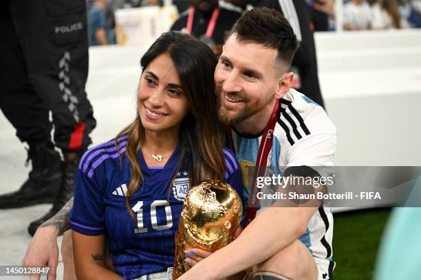 Lionel Messi of Argentina celebrates with his wife Antonela Roccuzzo and the FIFA World Cup Qatar 2022 Winner's Trophy following the FIFA World Cup...