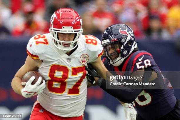 Travis Kelce of the Kansas City Chiefs runs with the ball as Christian Kirksey of the Houston Texans defends during the third quarter at NRG Stadium...