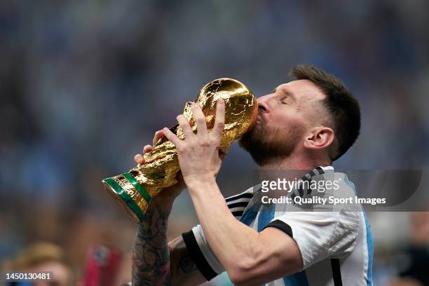 Lionel Messi of Argentina kisses the FIFA World Cup Qatar 2022 Winner's Trophy after the FIFA World Cup Qatar 2022 Final match between Argentina and...