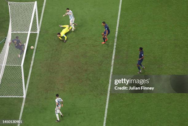 Lionel Messi of Argentina scores the team's third goal past Hugo Lloris of France while Jules Kounde of France attempts to clear off the goal line...