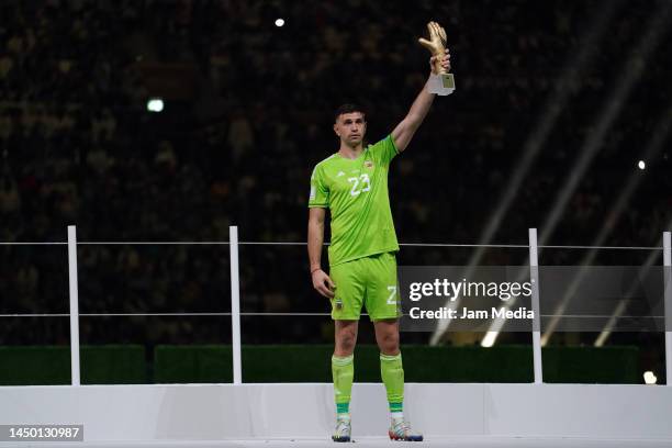 Emiliano Martinez goalkeeper of Argentina celebrates with Golden Glove trophy after winning the FIFA World Cup Qatar 2022 Final match between...