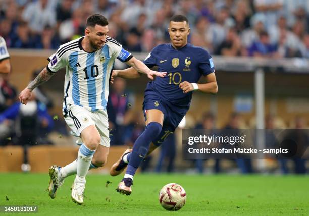 Lionel Messi of Argentina vies with Kylian Mbappe of France during the FIFA World Cup Qatar 2022 Final match between Argentina and France at Lusail...