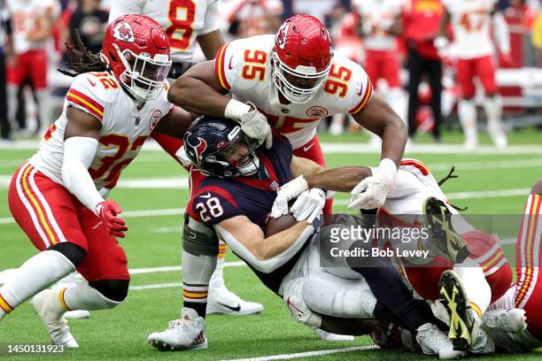 Rex Burkhead of the Houston Texans is tackled by Mike Danna and Chris Jones of the Kansas City Chiefs during the fourth quarter at NRG Stadium on...