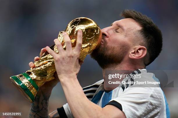 Lionel Messi of Argentina kisses the FIFA World Cup Qatar 2022 Winner's Trophy after the FIFA World Cup Qatar 2022 Final match between Argentina and...