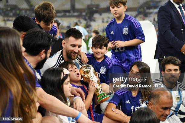 Lionel Messi of Argentina celebrates with the The FIFA World Cup Qatar 2022 Winner's Trophy, and his wife Antonela Roccuzzo and also their children...