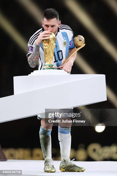 Lionel Messi of Argentina kisses the FIFA World Cup Qatar 2022 Winner's Trophy after the team's victory during the FIFA World Cup Qatar 2022 Final...