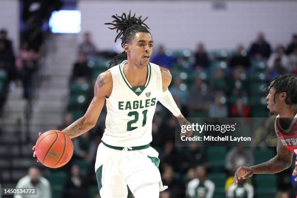 Emoni Bates of the Eastern Michigan Eagles dribbles up court in the first half during a college basketball game against the Detroit Mercy Titans at...
