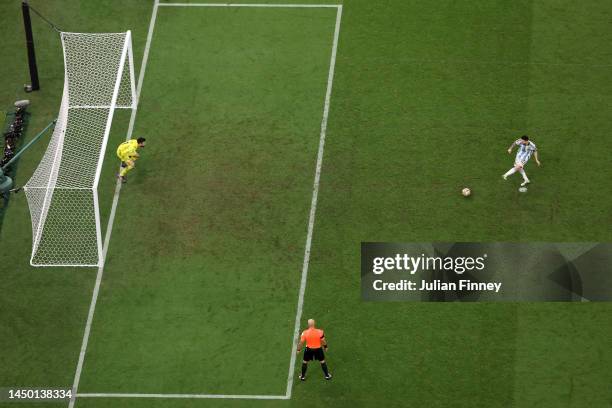 Lionel Messi of Argentina scores the team's first penalty past Hugo Lloris of France in the penalty shoot out during the FIFA World Cup Qatar 2022...