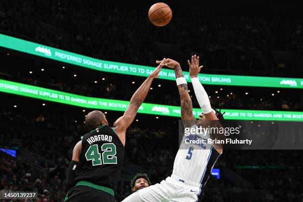 Paolo Banchero of the Orlando Magic attempts a shot over Al Horford of the Boston Celtics during the first quarter at the TD Garden on December 18,...