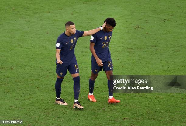 Kingsley Coman of France is consoled by Kylian Mbappe after missing the team's second penalty in the penalty shoot out during the FIFA World Cup...