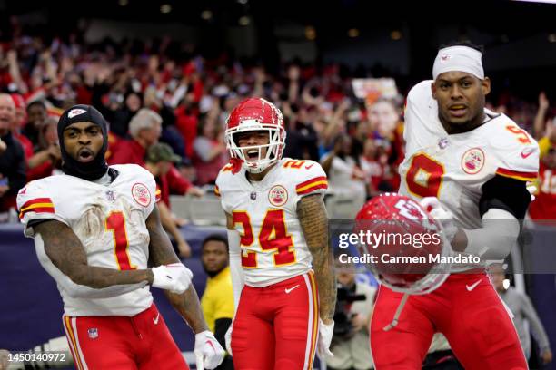 JuJu Smith-Schuster, Skyy Moore and Jerick McKinnon of the Kansas City Chiefs celebrates during overtime against the Houston Texans at NRG Stadium on...