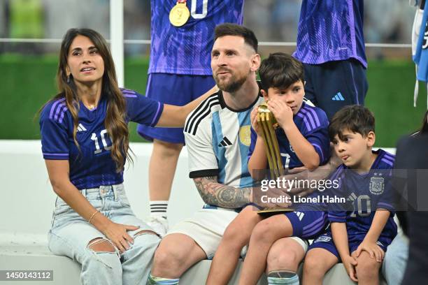 Lionel Messi of Argentina chats with his wife Antonella Roccuzzo after winning the FIFA World Cup Qatar 2022 Final match between Argentina and France...